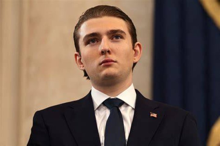 Barron Trump, 6'7″, towers over his father as he tenderly guides him as